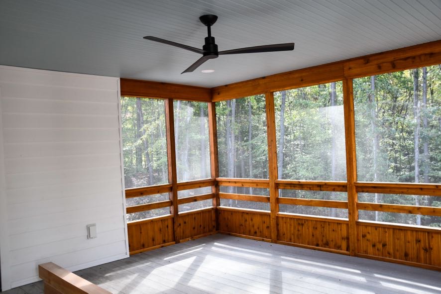 Custom coastal farmhouse exterior with white siding and wood accents built by Ryan Noble Construction


