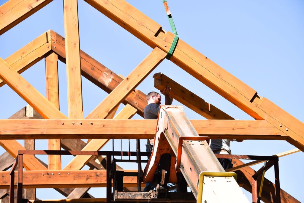 Timber frame porch under construction with exposed beams and rustic wood posts, built by Ryan Noble Construction in North Carolina