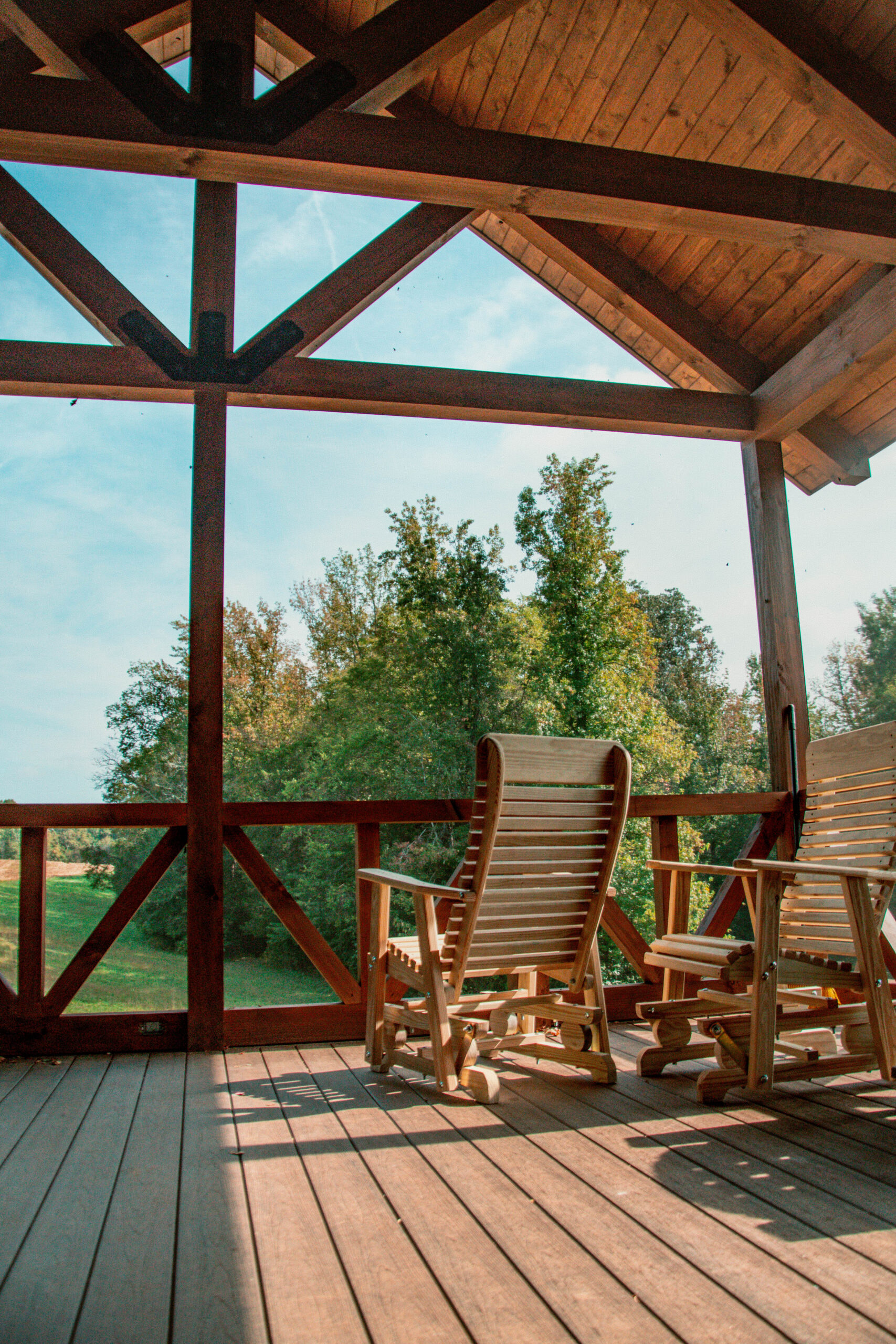A custom-built screened porch perfect for year-round outdoor living. The timber structure and stone steps blend seamlessly with the natural setting, adding warmth and function.