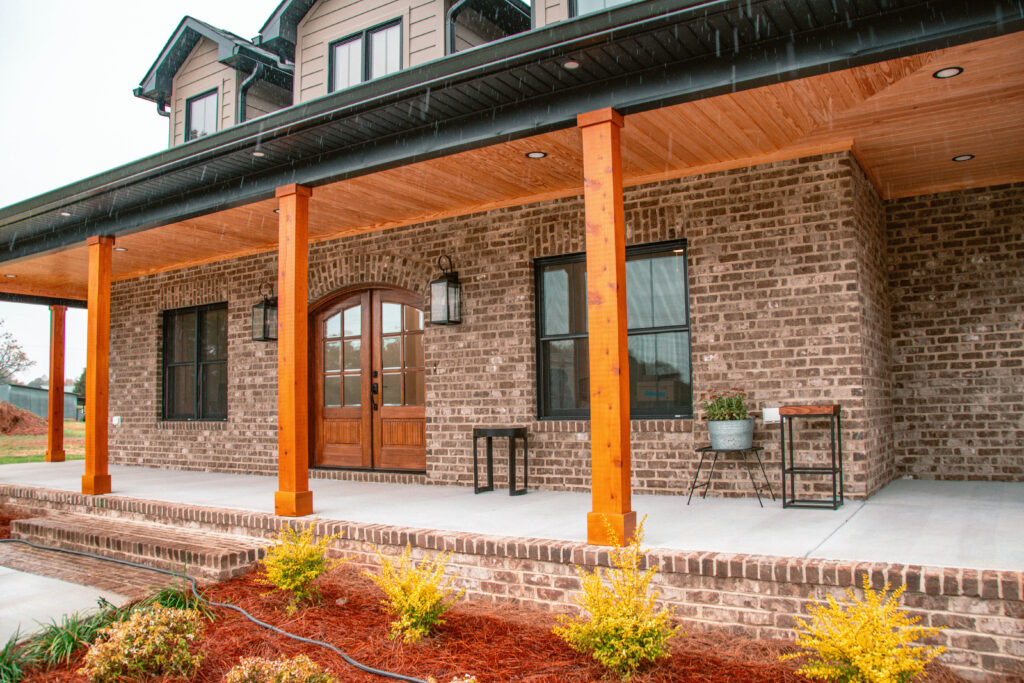modern home exterior porch with wood doors