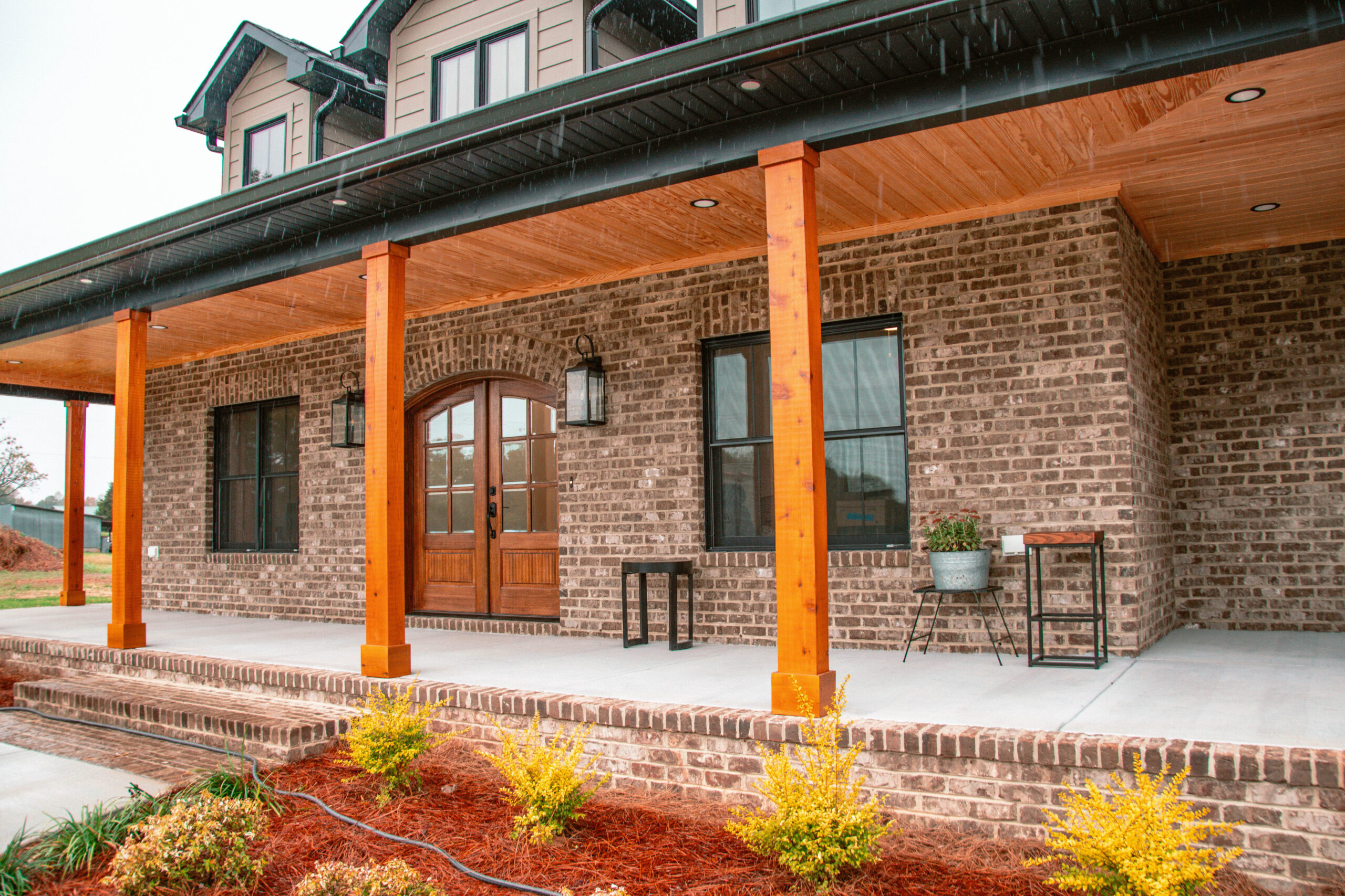 modern home exterior porch with wood doors
